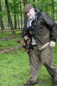 A man carrying his Terrier
